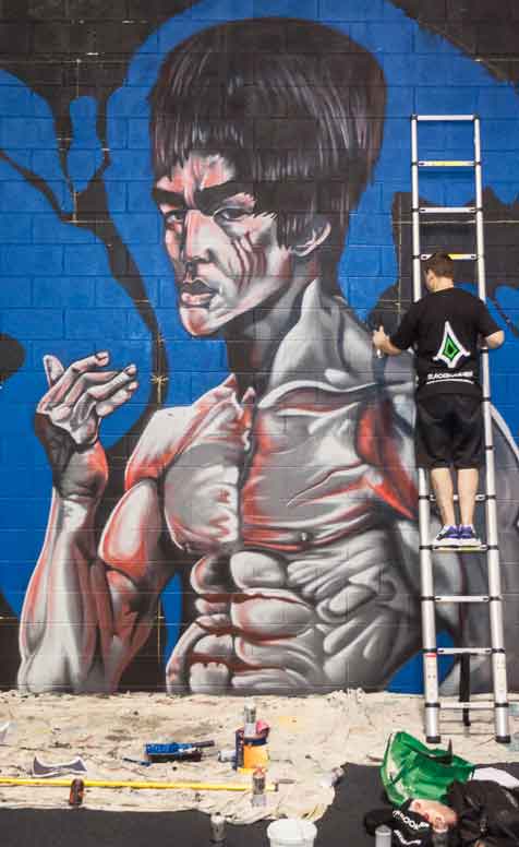 Mural FAQs — Costs, Process & Timelines | Blackbook Ink 2 sydney artist painting mural for a gym