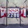 Crossfit 2200 graffiti on gym wall with fitness equipment.