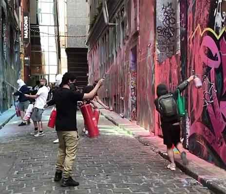 Graffiti Artists Painting Hosier Lane in Melbourne