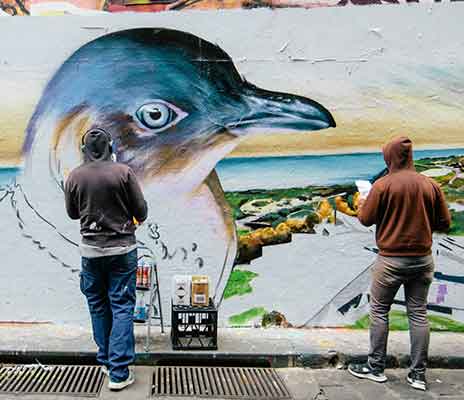 Graffiti Artists painting At Hosier Lane Melbourne