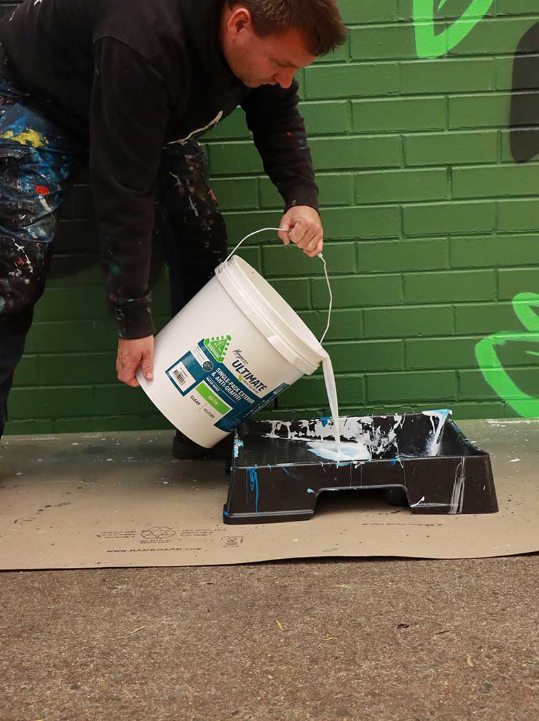 Getting ready to apply UV coating to a mural artwork