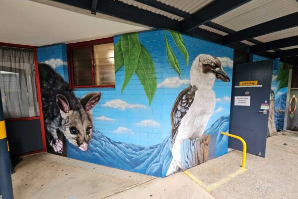 Canteen mural of a possum and kookaburra painted in Sydney School