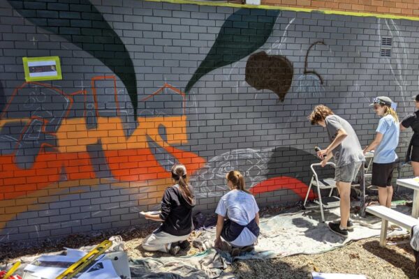 School students painting a mural