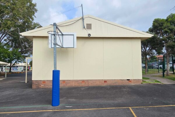 Before a school wall that was then painted with a mural