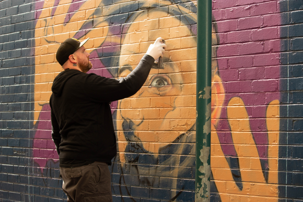 graffiti artists sydney - Paul Riots painting a graffiti style portrait in Bankstown