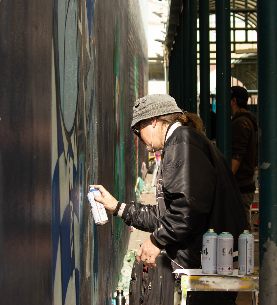 Mural artists Sydney working on a project for the Alleyway Gallery in Bankstown